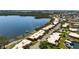 Beautiful aerial view of waterfront condos nestled on the bay with boat docks, lush landscaping, and serene water views at 3859 Catalina Dr, Bradenton, FL 34210