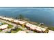 Scenic aerial view of waterfront condos with private dock access and lush landscaping along the Tampa Bay at 3859 Catalina Dr, Bradenton, FL 34210