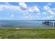 Waterfront backyard featuring lush green lawn and private dock, perfect for enjoying the water and serene views at 3859 Catalina Dr, Bradenton, FL 34210
