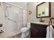 Modern bathroom with walk-in shower, dark wood vanity, neutral tiling, and stylish fixtures at 3859 Catalina Dr, Bradenton, FL 34210