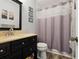 Bathroom with a modern vanity, framed mirror, and a shower with a gray patterned shower curtain at 3859 Catalina Dr, Bradenton, FL 34210
