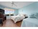 Tranquil bedroom with hardwood floors, a large window overlooking lush greenery, and comfortable bed at 3859 Catalina Dr, Bradenton, FL 34210