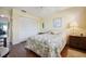 Bright bedroom featuring hardwood floors, closet, and a window overlooking lush greenery at 3859 Catalina Dr, Bradenton, FL 34210