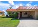Charming condo exterior featuring lush lawn, landscaping, a covered parking area, and proximity to the water at 3859 Catalina Dr, Bradenton, FL 34210