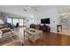 Comfortable living room showcasing hardwood floors, ample seating, and sliding doors to a waterfront patio at 3859 Catalina Dr, Bradenton, FL 34210