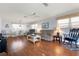 Bright living room with hardwood floors, a comfortable sofa, a rocking chair, and plenty of natural light from multiple windows at 3859 Catalina Dr, Bradenton, FL 34210