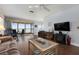 Bright and airy living room with hardwood floors and large windows overlooking the bay for serene indoor-outdoor living at 3859 Catalina Dr, Bradenton, FL 34210