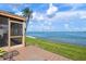 Outdoor patio with tile flooring and a waterfront view of the bay, perfect for relaxing and entertaining at 3859 Catalina Dr, Bradenton, FL 34210