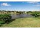 A serene backyard view of a pond surrounded by lush greenery at 4007 61St E Dr, Bradenton, FL 34203