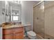 Bathroom featuring granite counters, a wood vanity, a glass shower, and a modern toilet at 4007 61St E Dr, Bradenton, FL 34203