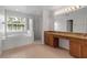 Bright bathroom with granite countertop double vanity, garden tub and glass shower at 4007 61St E Dr, Bradenton, FL 34203