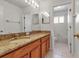 Bathroom features vanity with sink, large mirror, and tiled shower and bath at 4007 61St E Dr, Bradenton, FL 34203