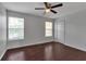 Bedroom with two windows, a ceiling fan and wood floors at 4007 61St E Dr, Bradenton, FL 34203