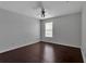 Bedroom with dark, well-maintained wood floors and a ceiling fan illuminated by light from the window at 4007 61St E Dr, Bradenton, FL 34203