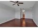 Spacious bedroom with a ceiling fan, beautiful wood floors and a glimpse into an ensuite bathroom at 4007 61St E Dr, Bradenton, FL 34203