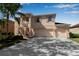 Two-story home featuring a three car garage, balcony, manicured lawn and lush landscaping at 4007 61St E Dr, Bradenton, FL 34203
