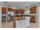 Kitchen featuring stainless steel appliances, wood cabinets, and granite countertops at 4007 61St E Dr, Bradenton, FL 34203