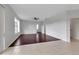 Open concept living room featuring tiled and wood flooring, ceiling fan, and light gray walls at 4007 61St E Dr, Bradenton, FL 34203