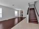 Open-concept living room with wood floors, staircase, and natural light at 4007 61St E Dr, Bradenton, FL 34203