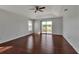 Main bedroom featuring wood flooring, tray ceilings, ceiling fan, and sliding glass doors at 4007 61St E Dr, Bradenton, FL 34203