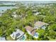 Stunning aerial view of waterfront homes surrounded by lush trees, with pools and bridges visible in the background at 4013 Red Rock Ln, Sarasota, FL 34231