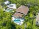 Stunning aerial view of a home featuring a refreshing pool and lush landscaping creating a private oasis at 4013 Red Rock Ln, Sarasota, FL 34231