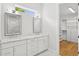Bathroom with double vanity, marble countertops, and a walk-in closet at 4013 Red Rock Ln, Sarasota, FL 34231