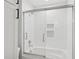 Modern bathroom featuring white subway tile and a glass-enclosed tub and shower combination at 4013 Red Rock Ln, Sarasota, FL 34231