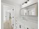 Modern bathroom with a white vanity, contemporary fixtures, and an open doorway to the bedroom at 4013 Red Rock Ln, Sarasota, FL 34231