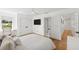 Bright bedroom featuring light hardwood floors, ceiling fan, double door closet and adjoining bathroom at 4013 Red Rock Ln, Sarasota, FL 34231