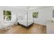 Bright bedroom featuring large windows, hardwood floors, a ceiling fan, and white accents at 4013 Red Rock Ln, Sarasota, FL 34231