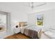 Comfortable bedroom with view of the yard, hardwood flooring, ceiling fan, and white accents at 4013 Red Rock Ln, Sarasota, FL 34231