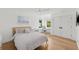 Bright bedroom featuring light hardwood floors, ceiling fan, double door closet and lots of light at 4013 Red Rock Ln, Sarasota, FL 34231