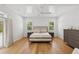 Bedroom with hardwood floors, ceiling fan, and natural light streaming through plantation shutters at 4013 Red Rock Ln, Sarasota, FL 34231