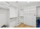 Walk-in closet with custom shelving and built-in drawers for ample storage at 4013 Red Rock Ln, Sarasota, FL 34231