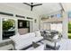 Stylish covered patio with outdoor seating and dining areas, seamlessly connecting indoor and outdoor spaces at 4013 Red Rock Ln, Sarasota, FL 34231