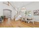 Open dining room featuring wood floors, staircase, and modern chandelier at 4013 Red Rock Ln, Sarasota, FL 34231