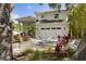 A lovely home showcasing an attached double garage, lush greenery, and a charming front yard at 4013 Red Rock Ln, Sarasota, FL 34231