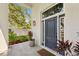 An elegant front door featuring sidelights, stylish lighting and lush landscaping for an inviting entrance at 4013 Red Rock Ln, Sarasota, FL 34231