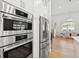 Stainless steel refrigerator and built-in ovens complement the bright, modern kitchen design at 4013 Red Rock Ln, Sarasota, FL 34231