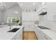 Modern kitchen features white cabinetry, quartz countertops, and stainless steel appliances at 4013 Red Rock Ln, Sarasota, FL 34231