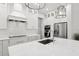 Contemporary kitchen with sleek white cabinetry, quartz countertops and modern appliances at 4013 Red Rock Ln, Sarasota, FL 34231