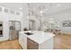 Kitchen island with stainless steel appliances and stairway to second floor at 4013 Red Rock Ln, Sarasota, FL 34231