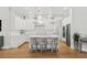 Bright white kitchen featuring an island with seating, stainless steel appliances, and modern pendant lighting at 4013 Red Rock Ln, Sarasota, FL 34231