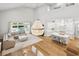 Open-concept living space with a grand chandelier, a comfortable seating area, and a seamless connection to the kitchen at 4013 Red Rock Ln, Sarasota, FL 34231