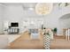 Open-concept living area with hardwood floors, modern furnishings, and chandelier lighting at 4013 Red Rock Ln, Sarasota, FL 34231
