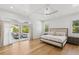Bright main bedroom with ceiling fan, wood floors, and patio access at 4013 Red Rock Ln, Sarasota, FL 34231