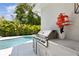 Well-equipped outdoor kitchen with grill, counter space, and a view of the sparkling pool at 4013 Red Rock Ln, Sarasota, FL 34231