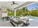 Beautiful covered patio with dining and lounging area, ceiling fan, and view of the pool at 4013 Red Rock Ln, Sarasota, FL 34231