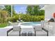 Relaxing outdoor living area with a pool, lush landscaping, outdoor kitchen and comfortable seating at 4013 Red Rock Ln, Sarasota, FL 34231